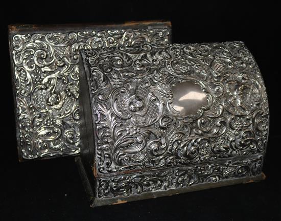 An embossed pierced silver-mounted stationery box, London 1905, Goldsmiths & Silversmiths Co Ltd, with matching desk blotter.